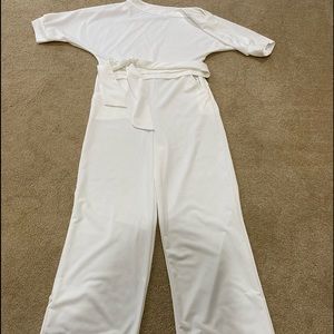 White jumpsuit one side off the shoulder